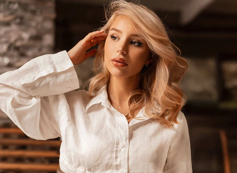 blonde woman in white button up shirt | Premier Cosmetic LA