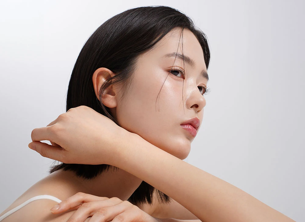 asian woman resting on arm | Premier Cosmetic LA